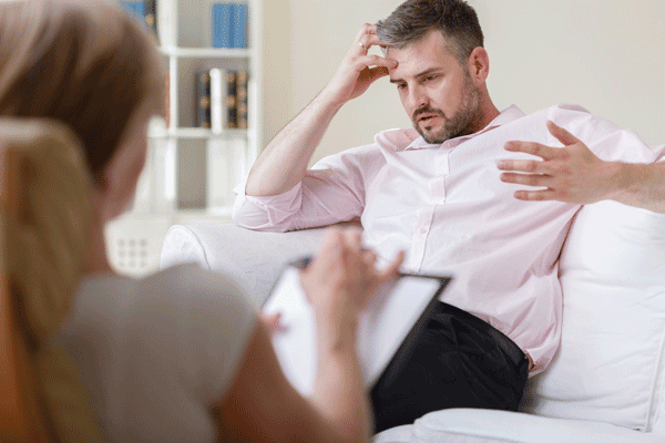 sober business man seeing addiction therapist for motivational interviewing