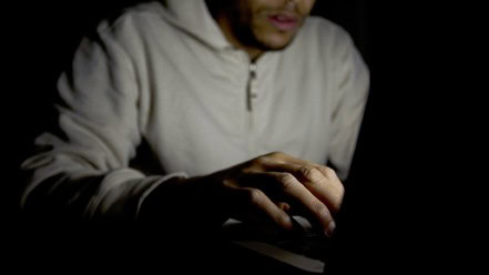 Man on laptop at night, concept of technology addiction