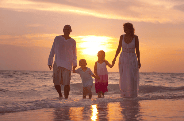 Sober parents and children on beach