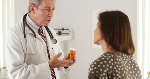Doctor prescribing opiates to patient during prescription drug epidemic