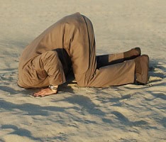 image of man with head buried in sand to symbolize avoidance