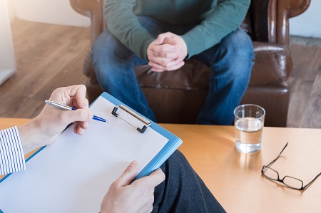image of an addiction therapist treating a client for addiction