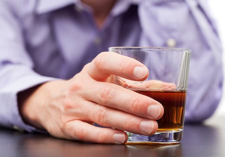 Businessman drinking with addiction