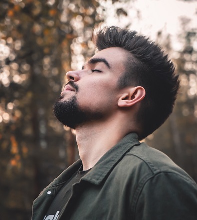 image of a man practicing mindful breathing to reduce stress