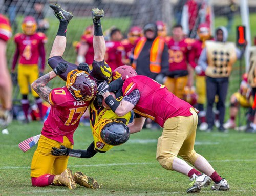 image of pro football players tackling each other to symbolize pro football being more dangerous than substance use